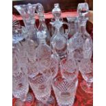 An assorted lot of glasses, including red and white wine glasses, a selection of decanters, fruit