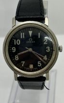 A 20th century Omega military issue wristwatch, the black dial with calendar aperture and white