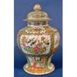 19th century famille rose baluster shaped vase and cover with typical floral bird and butterfly