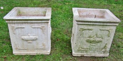 A pair of weathered composition stone planters of square form with classical raised relief detail,