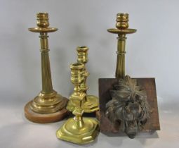 A pair of bronze reeded candlesticks raised on a circular marble plinth 23 cm high, a pair of