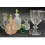 A mixed selection of items to include a single wine glass, three scent bottles, a collection of