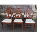 A set of six Georgian style stained beechwood dining chairs, the shield shaped backs with pierced