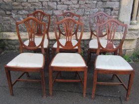 A set of six Georgian style stained beechwood dining chairs, the shield shaped backs with pierced