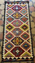 A Chobi Kilim runner, with repeating stepped medallion between white divisions, 149cm x 66cm approx