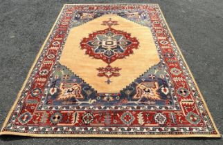 A Modern machine made rug of middle eastern design with central medallion in bright colours, 290cm x