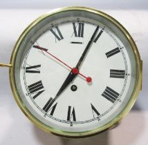 A brass bulkhead clock with polished brass case, 20inch dial