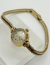 An Omega 9ct gold ladies’ wristwatch, on 9ct gold chain strap, 12mm case, 13g gross, with original