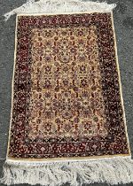 A small silk all over floral patterned rug, 95cm x 60cm approx