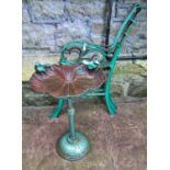 A small weathered cast iron bird bath of shell form with bird surmounts, raised on a central