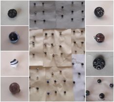 A collection of Victorian glass ball waistcoat buttons including faceted buttons and others with