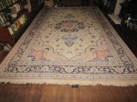 A large eastern wool carpet with pale cream ground, with central medallion, abstract floral detail