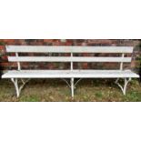 A vintage bench with painted wooden lathes, raised on sprung steel supports, 244cm long (af)