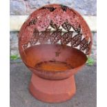 A weathered spherical shaped fire pit with pierced leaf design, 50cm diameter approx