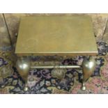 A Georgian brass kettle or pot stand, rectangular with axe shaped handles raised on shaped forelegs,