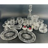 A large selection of cut glass ware including eight sorbet dishes, lidded jars decanters,