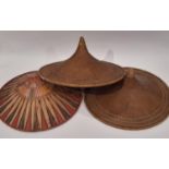 A pair of oriental hats in traditional woven style diameter 57cm, together with a similar coloured