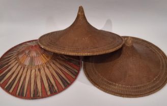 A pair of oriental hats in traditional woven style diameter 57cm, together with a similar coloured