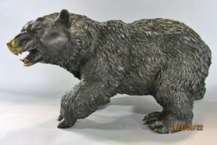 A cast bronze study of a brown bear on all fours, 33 cm long x 27 cm high