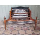 A Georgian style fire basket with serpentine front and pierced grill beneath urn finials, 77 cm x 50