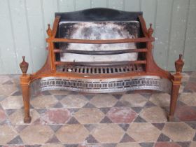 A Georgian style fire basket with serpentine front and pierced grill beneath urn finials, 77 cm x 50