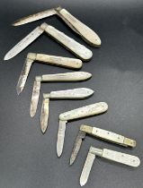 A collection of eight mother of pearl and silver folding fruit knives by various makers