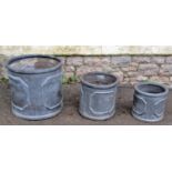 A graduated set of three squat cylindrical faux lead planters, the largest 36cm diameter x 42cm high