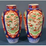 A pair of 19th century Imari shouldered vases with typical landscape and foliate detail, 25cm high