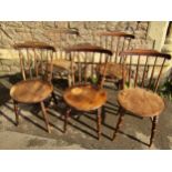 A set of five stained beech Swedish stickback kitchen chairs with circular seats