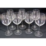A mixed collection of 13 modern red and white tall stemmed wine glasses together with water
