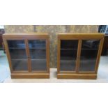A pair of early 20th century walnut floorstanding dwarf side cabinets/bookcases with inlaid