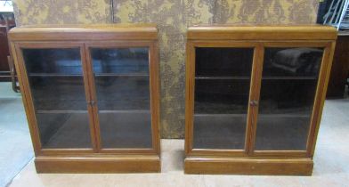 A pair of early 20th century walnut floorstanding dwarf side cabinets/bookcases with inlaid