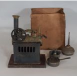 Vertical model steam engine with single cylinder and spoked fly wheel. Height 17cm