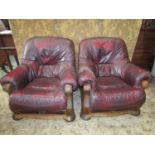 A pair of oak framed drawing room chairs with carved detail, maroon coloured upholstery