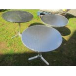 A pair of good quality stainless steel and cast alloy bistro tables with circular tops, 70cm