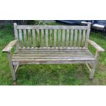 A Bramble Crest weathered teak three seat garden bench with slatted seat and back with curved
