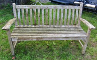 A Bramble Crest weathered teak three seat garden bench with slatted seat and back with curved