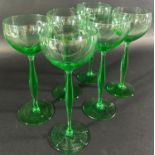 Six slender green hock wine glasses, 195cm high