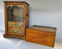 An early 20th century oak smokers cabinet with fitted interior and three drawers behind a single