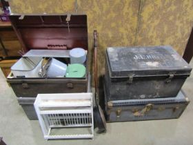 An old tin trunk containing various kitchenalia, a small painted plate rack, two further tin