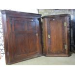 A Georgian elm country made hanging corner cupboard enclosed by a panelled door, a further example