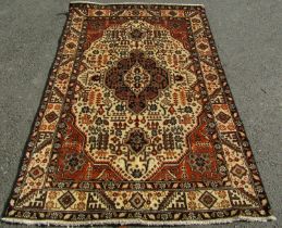 A north west Persian Tabriz rug, with a central stepped medallion and stylised flowers on a cream