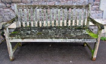 A weathered teak three seat garden bench with slatted seat and back, 150cm long