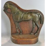 An Equestrian cast bronze and oak backed equestrian doorstop