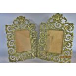 A pair of neoclassical style gilded frames with mask detail to the scrolling garland frame, 38 cm
