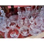 A large quantity of assorted glassware including decanters, vases, champagne flutes, fruit bowls,