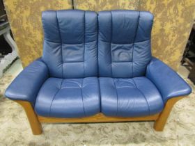 A Stressless Windsor high back two seat sofa in Paloma Oxford blue leather and beechwood together