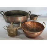 A large 19th century copper double handle preserving bowl, a copper dough kneading bowl, a brass