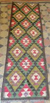 A Maimana Kilim runner, with repeating multicoloured medallions,202cm x 64cm approx