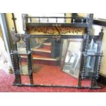 An Edwardian overmantle mirror with seven mirror plates, the ebonised frame with gilt detail, the